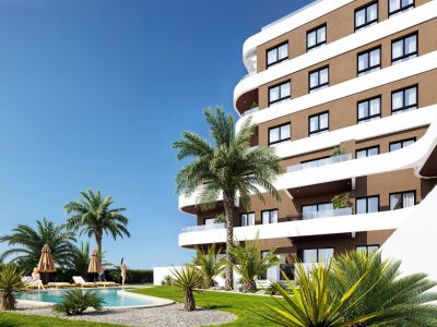 New-build apartment building in Guardamar del Segura with curved architecture, glass railings and landscaped communal gardens